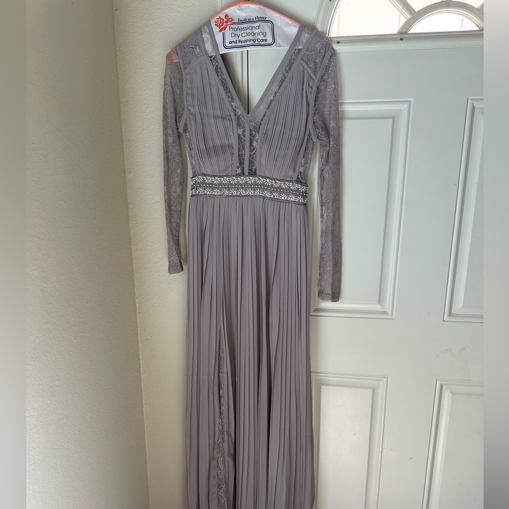 TNFC Pleated Maxi Dress with long sleeves, lace inserts, and embellished waist.